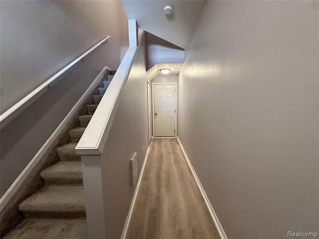 Entry foyer and staircase with hardwood flooring
