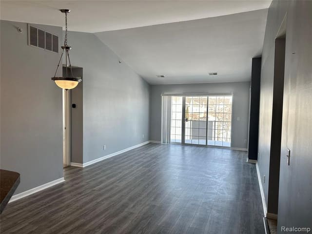 Open living area with hardwood floors and large windows