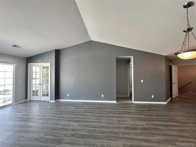 Living space with hardwood floors and oversized windows