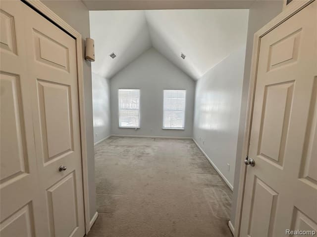 Carpeted bedroom with vaulted ceiling