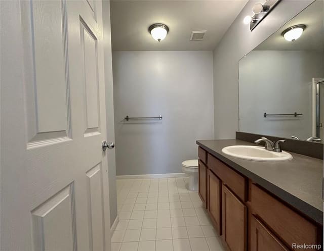 Full bathroom with vanity and framed mirror