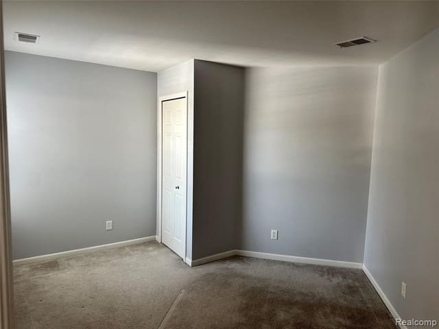 Second bedroom with carpet and a large window