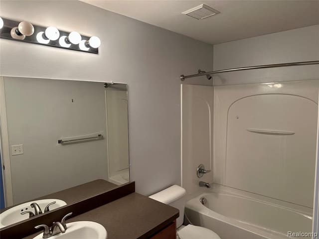 Full bathroom with tub and shower surround