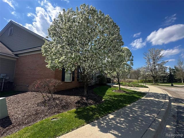 Front exterior with landscaped lawn